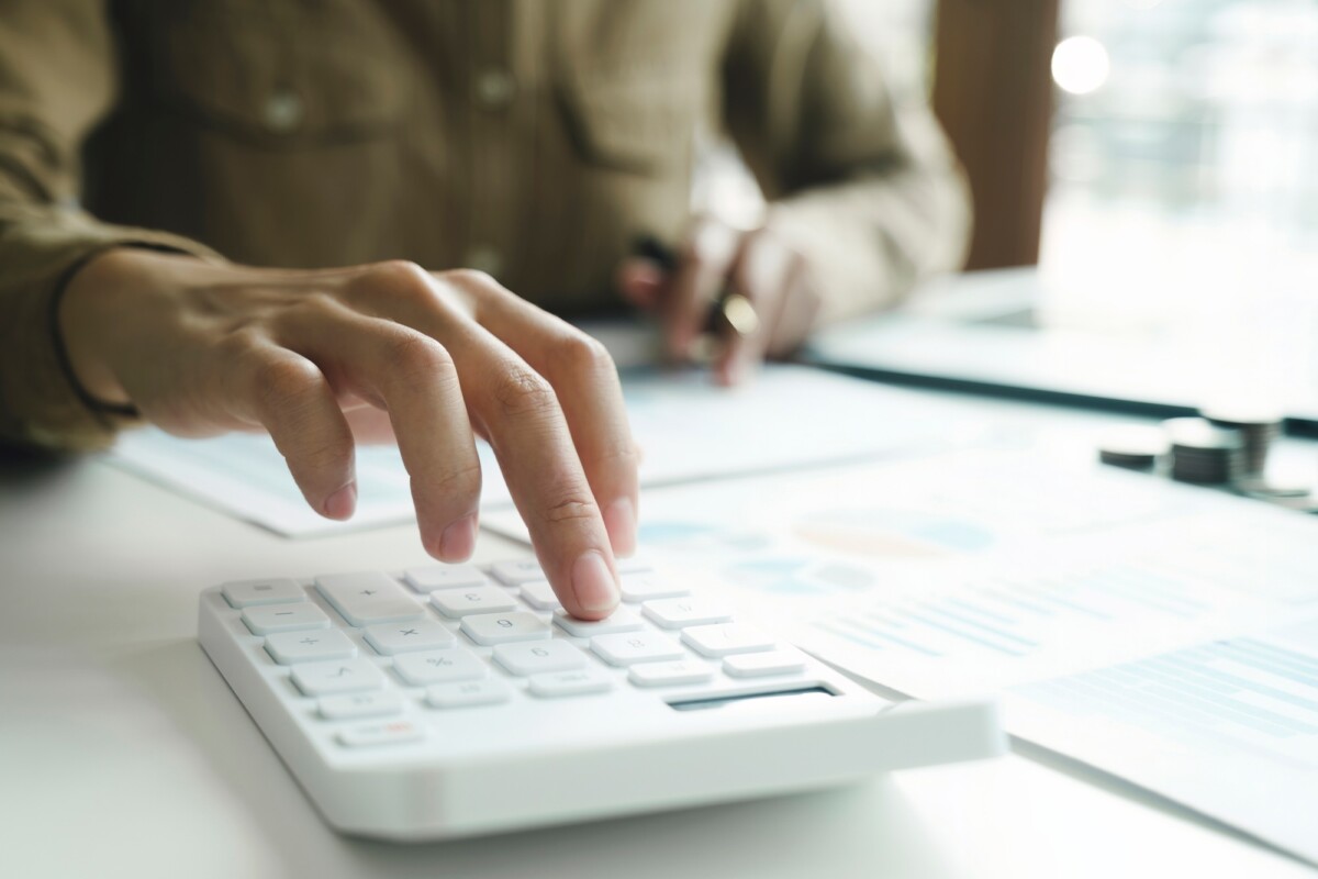 Accountant using calculator for calculate finance report in office check n go texas city