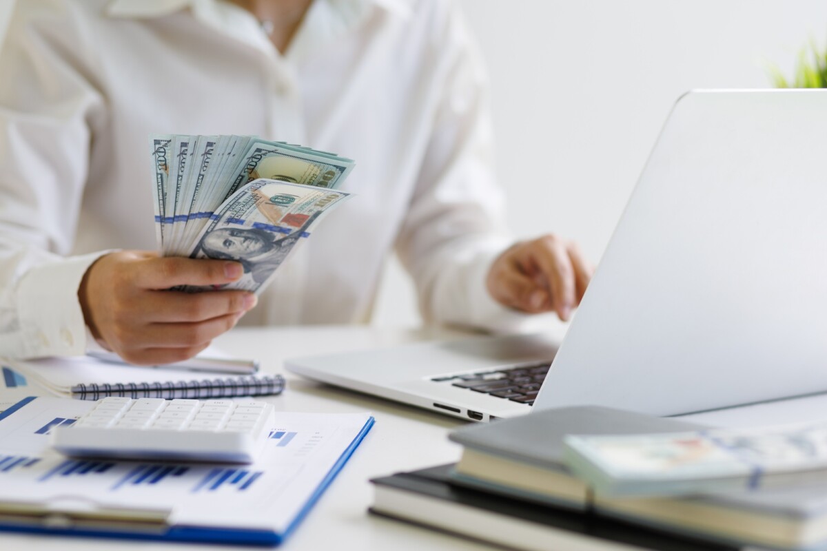 Female accountant holding cash banknotes counting money. check n go st louis mo