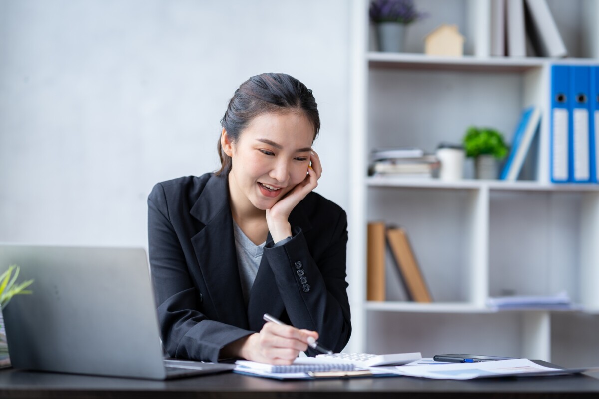 Portrait of an Asian businesswoman pressing a calculator, looking at a notebook, analyzing data, and Portrait of an Asian businesswoman pressing a calculator, looking at a notebook, analyzing data, and