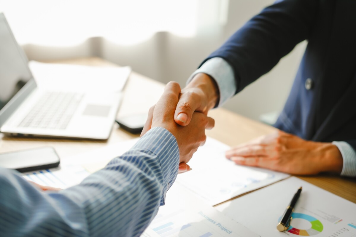 Businessman conducts financial discussions, sealing deals with handshakes. Expert in accounts, loans
