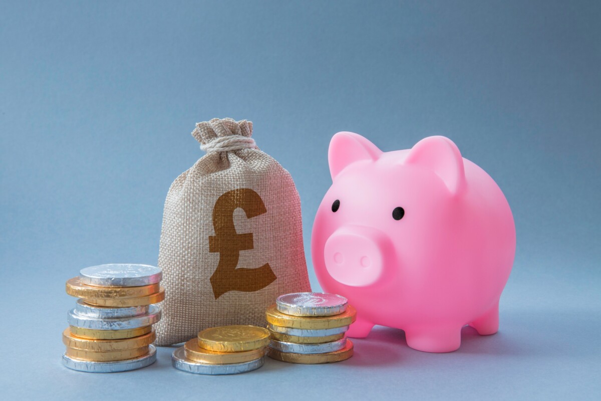 Home finance concept of family savings account with cash, money and pink piggy bank with copy space Home finance concept of family savings account with cash, money and pink piggy bank with copy space