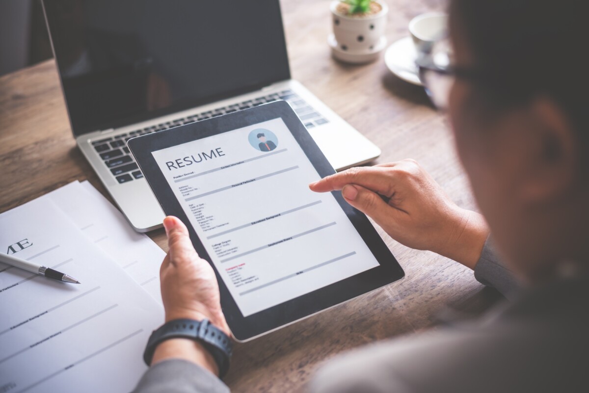 People are filling out their personal resume on the tablet for online job applications.