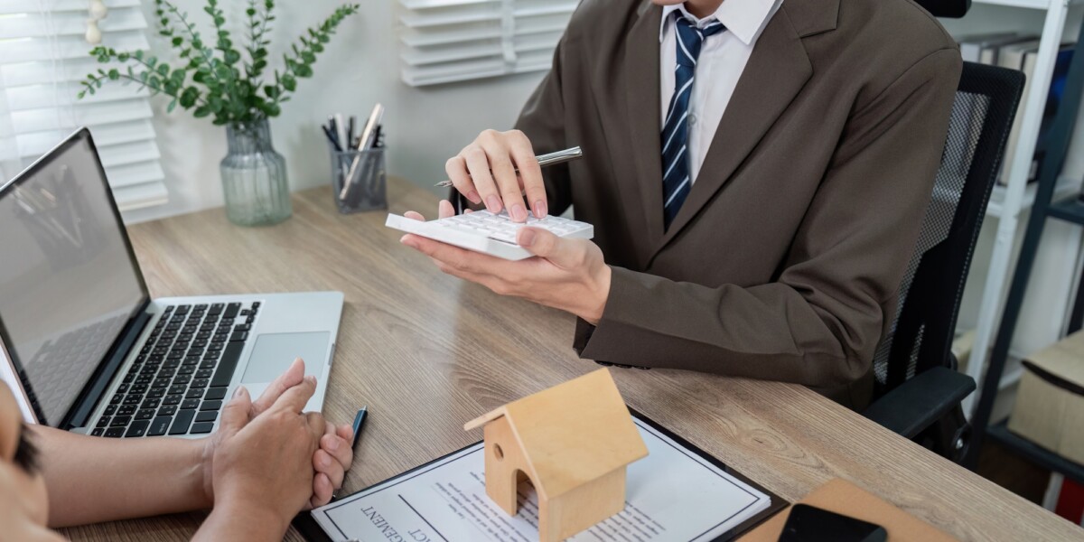 Real Estate Agent Assessing Loan Options with Client for Optimal Property Investment Real Estate Agent Assessing Loan Options with Client for Optimal Property Investment