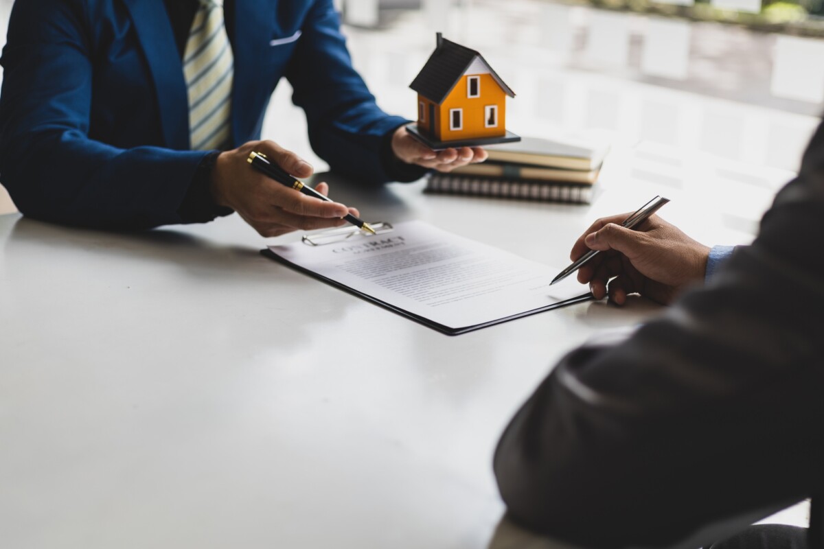 Real estate agent is discussing and explaining the terms of the home purchase contract.
